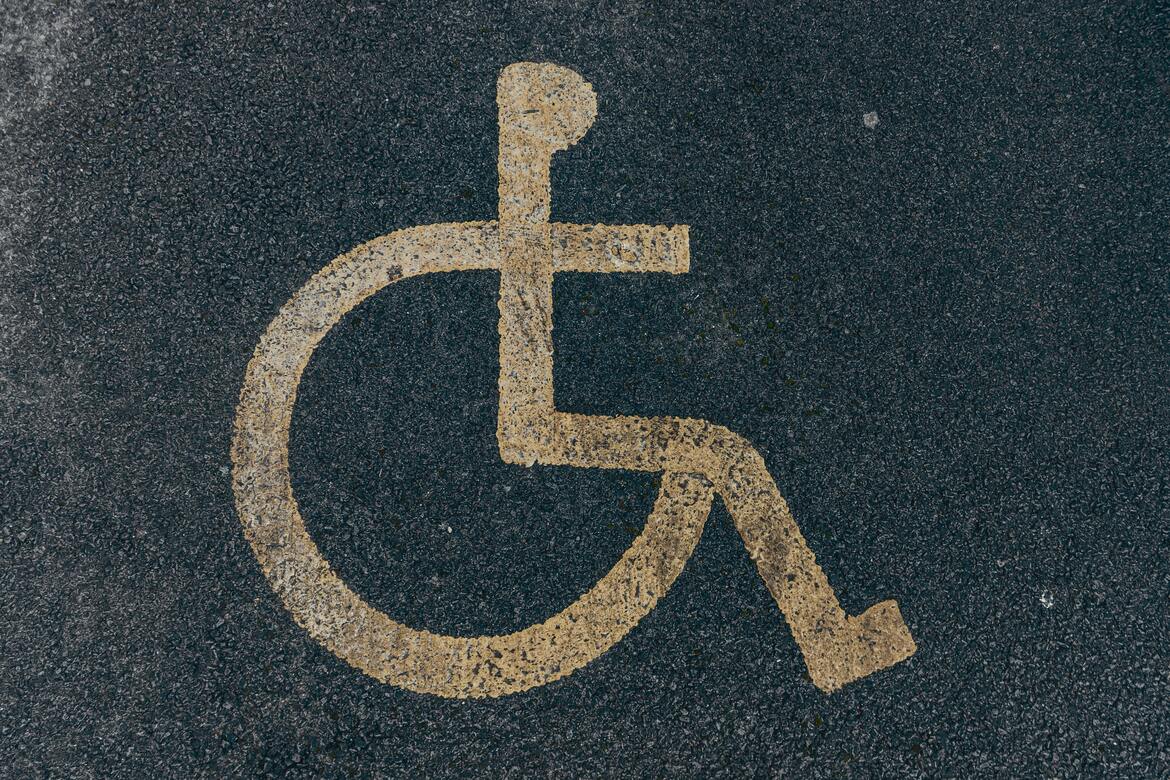 A wheelchair sign painted on the road