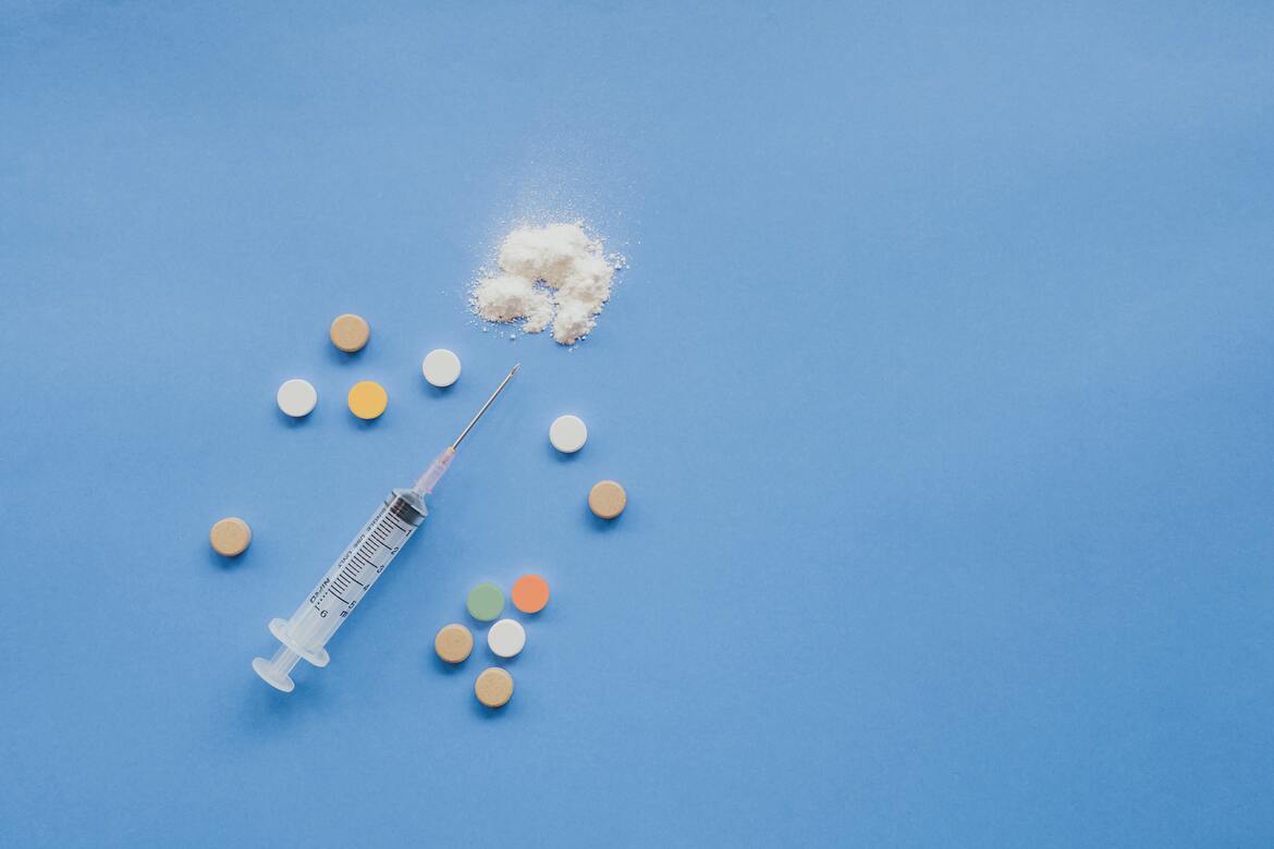 Syringe, pills and white powder