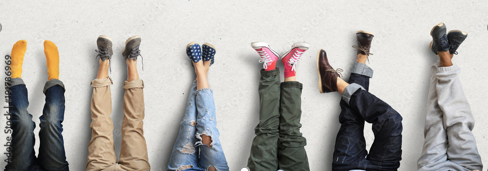 six pairs of young people's legs in a row