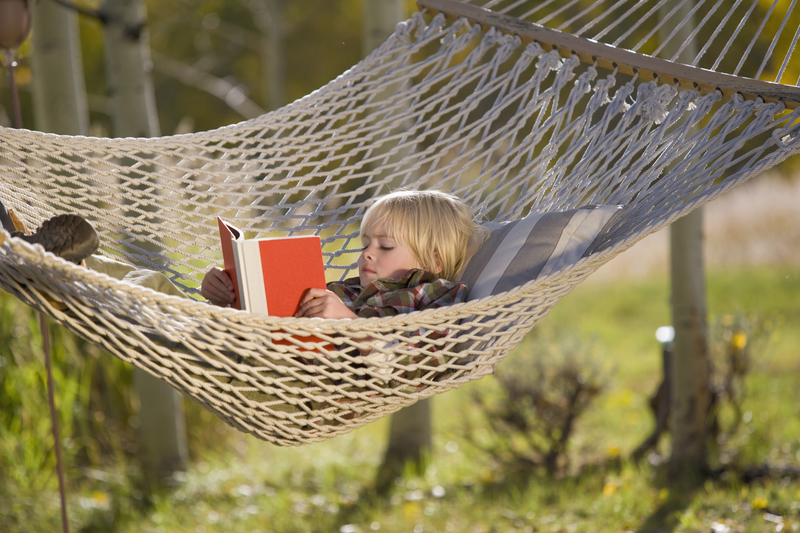 child reading in a hammock