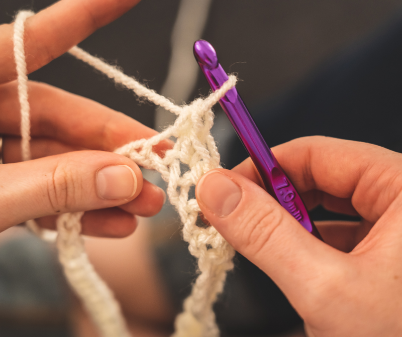 Person using a crochet needle