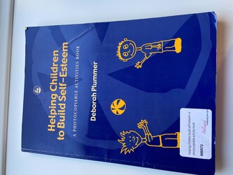 Blue book cover, with cartoon children titled; Helping children build self-esteem- a photocopiable activities book 