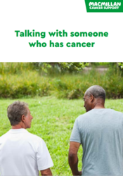 Two people standing in grass 