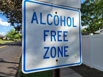 Alcohol free zone sign which is blue and white 