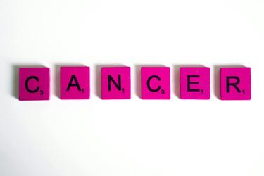 Pink word tiles spelling cancer 