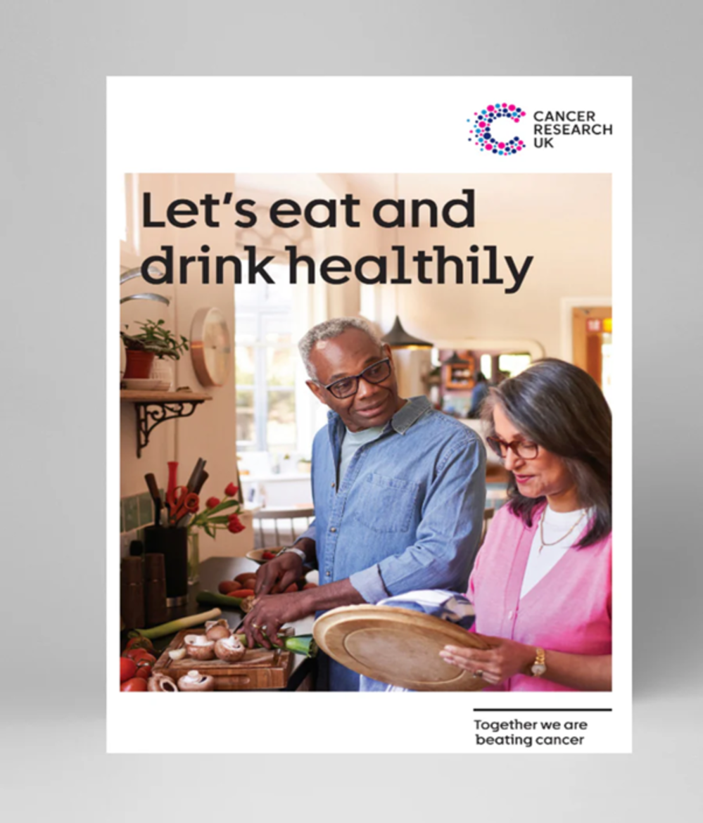 A person and  a person standing in a kitchen 